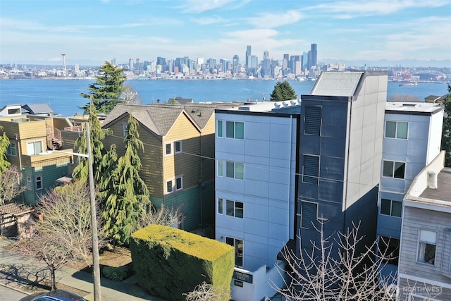drone / aerial view with a city view and a water view