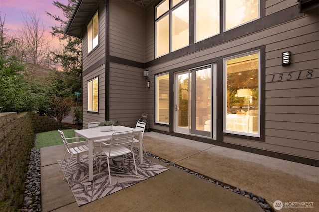 patio terrace at dusk with outdoor dining space