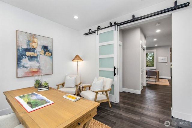 office space with recessed lighting, dark wood-style flooring, baseboards, and a barn door