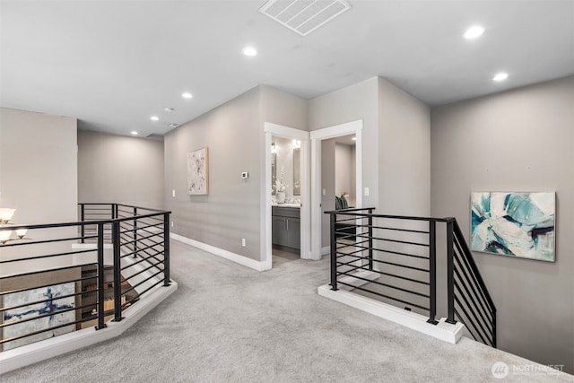 hall featuring carpet floors, recessed lighting, visible vents, an upstairs landing, and baseboards