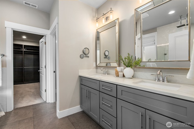 bathroom featuring double vanity, tile patterned flooring, a sink, and visible vents