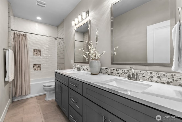 bathroom featuring shower / tub combo with curtain, tile patterned flooring, visible vents, and a sink