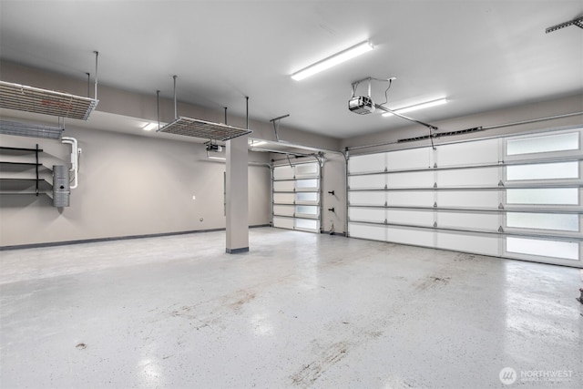 garage with baseboards and a garage door opener