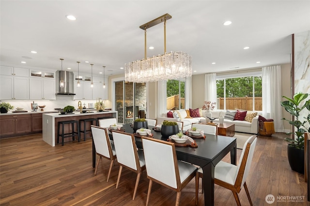 dining area featuring dark wood-type flooring and recessed lighting