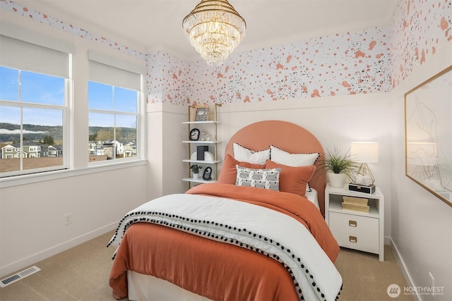 bedroom featuring a notable chandelier, carpet floors, visible vents, and baseboards