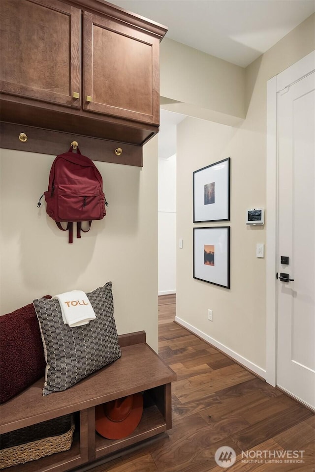 mudroom with dark wood-style flooring and baseboards