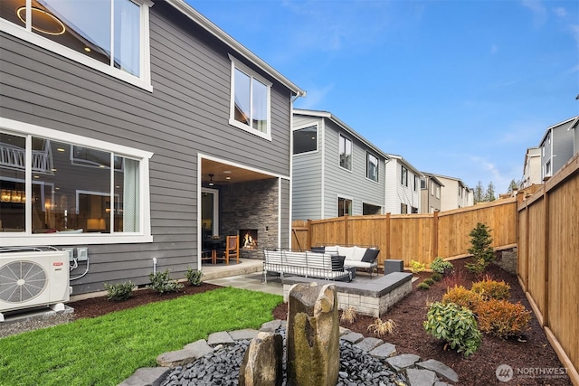 back of house with ac unit, a fenced backyard, an outdoor living space, and a patio