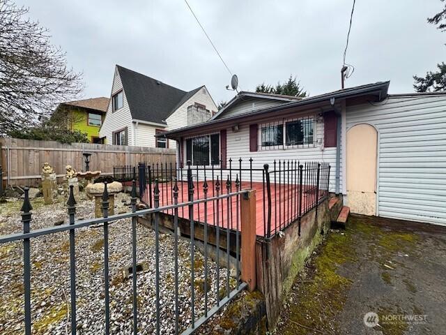 back of house with fence