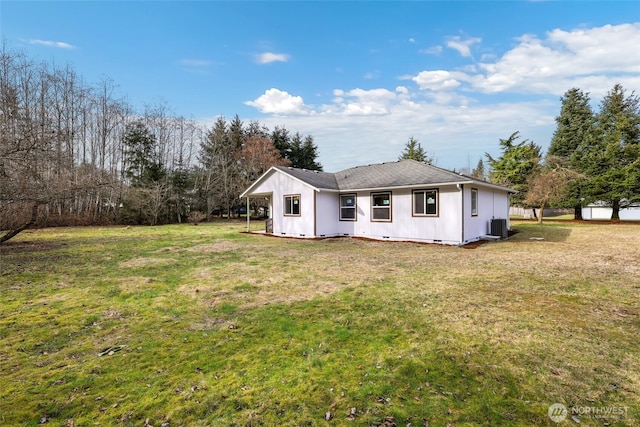 rear view of property with crawl space, cooling unit, and a lawn