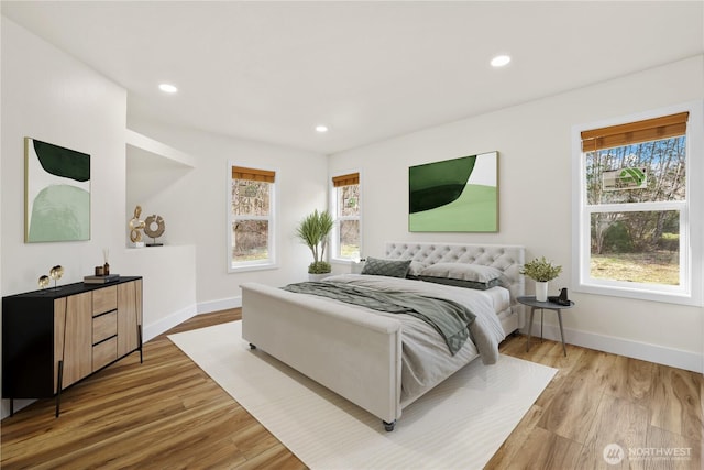 bedroom with recessed lighting, wood finished floors, and baseboards