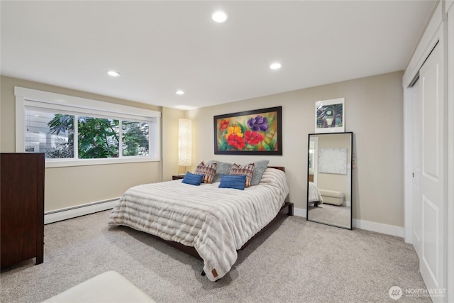 bedroom with baseboards, a baseboard radiator, carpet, a closet, and recessed lighting