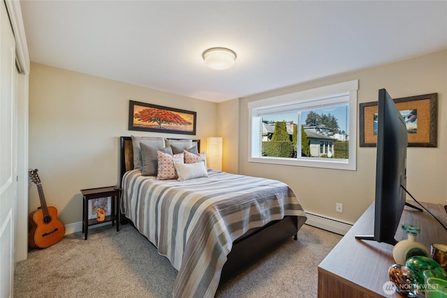 bedroom with baseboards, a baseboard heating unit, and light colored carpet