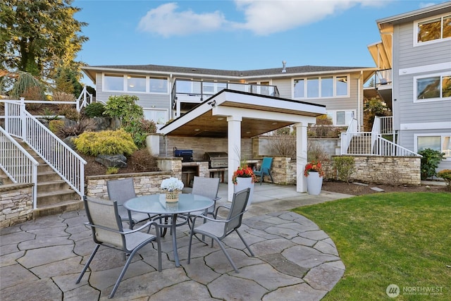 view of patio / terrace with stairway, outdoor dining area, and area for grilling