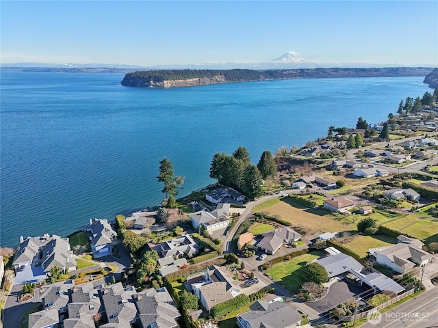 drone / aerial view featuring a residential view and a water view