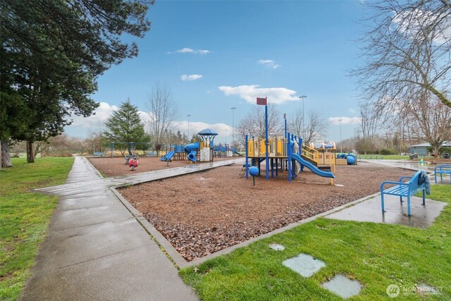 community jungle gym with a yard