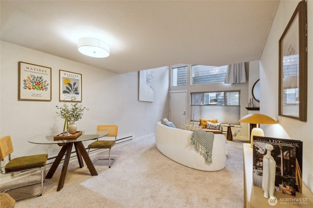 living area with a baseboard radiator, baseboards, and carpet flooring