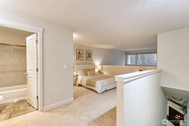 bedroom with baseboards and carpet floors