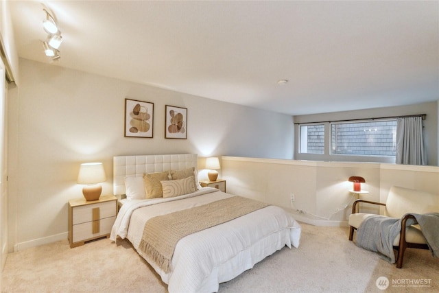 carpeted bedroom featuring baseboards