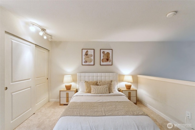 bedroom featuring baseboards and carpet flooring