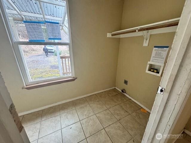 washroom with light tile patterned floors, laundry area, washer hookup, baseboards, and electric dryer hookup