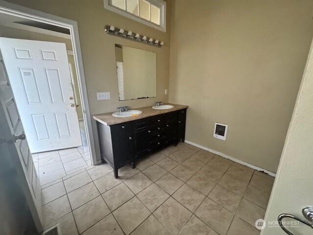 bathroom featuring double vanity, tile patterned flooring, and a sink