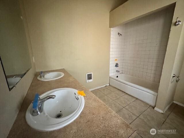 full bathroom featuring shower / bathtub combination, tile patterned flooring, a sink, and baseboards