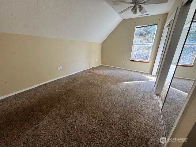 bonus room with carpet floors, ceiling fan, baseboards, and lofted ceiling