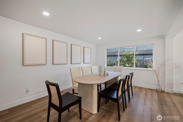 dining area with baseboards, wood finished floors, and recessed lighting