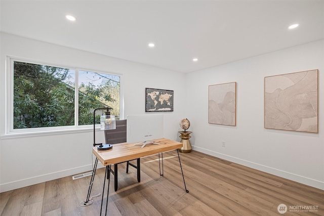 home office featuring light wood-style floors, baseboards, visible vents, and recessed lighting