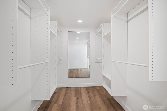 walk in closet with wood finished floors