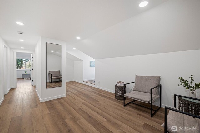 sitting room featuring baseboards, vaulted ceiling, wood finished floors, and recessed lighting