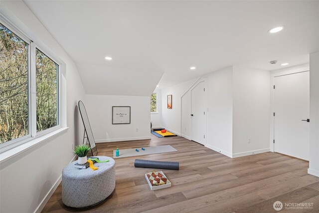 interior space featuring baseboards, wood finished floors, and recessed lighting