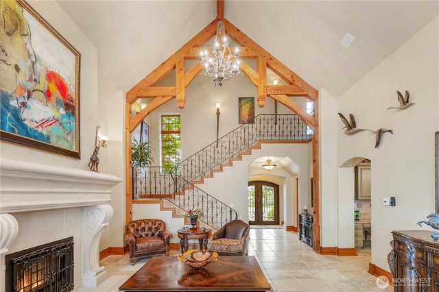 1939 49th St, Port Townsend, WA 98368 - living room with high vaulted ceiling, a warm lit fireplace, arched walkways, plenty of natural light, and stairway