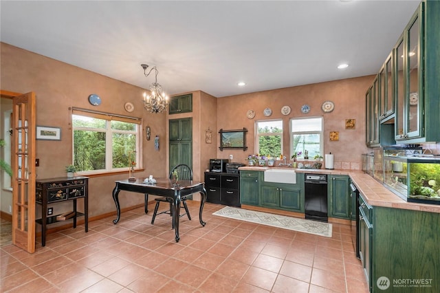 1939 49th St, Port Townsend, WA 98368 - kitchen with green cabinetry, light countertops, a sink, light tile patterned floors, and a chandelier