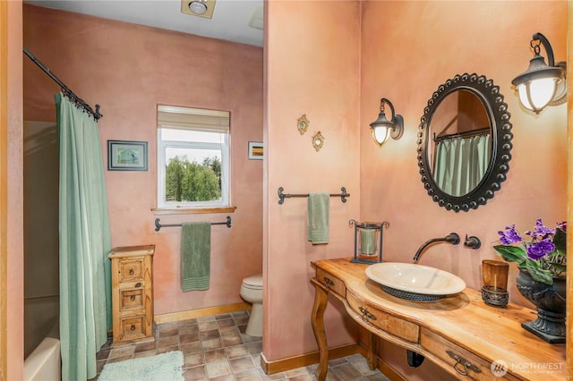 1939 49th St, Port Townsend, WA 98368 - full bathroom with a sink, toilet, shower / bath combo, baseboards, and stone finish floors