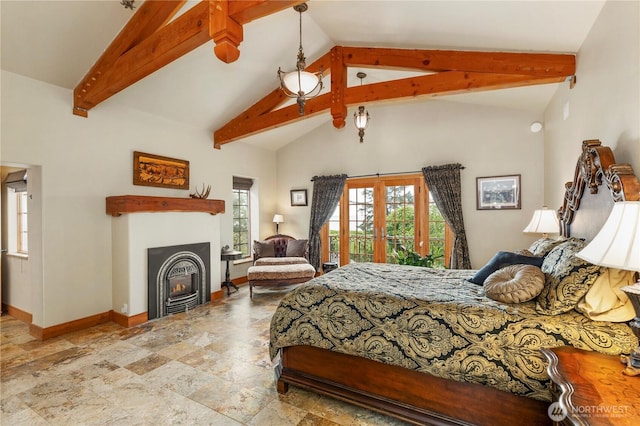 1939 49th St, Port Townsend, WA 98368 - bedroom with access to exterior, baseboards, beamed ceiling, stone finish floors, and a warm lit fireplace