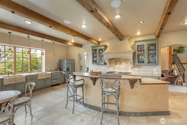 1939 49th St, Port Townsend, WA 98368 - kitchen with arched walkways, appliances with stainless steel finishes, gray cabinets, a sink, and beam ceiling