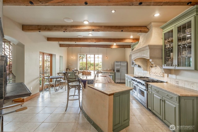 1939 49th St, Port Townsend, WA 98368 - kitchen with green cabinetry, stainless steel appliances, recessed lighting, a kitchen island, and baseboards