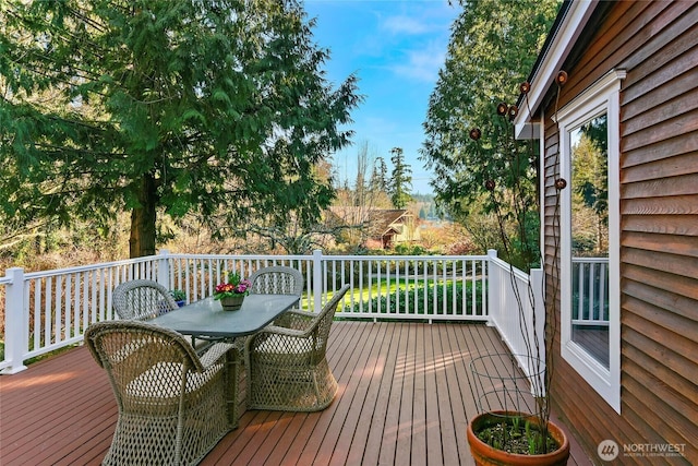 wooden deck featuring outdoor dining space