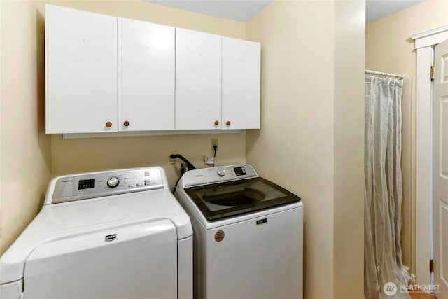 washroom with cabinet space and washing machine and dryer