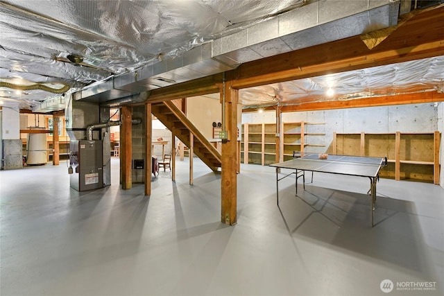 unfinished basement with stairway and heating unit