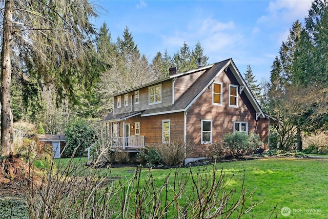 exterior space with a yard and a chimney