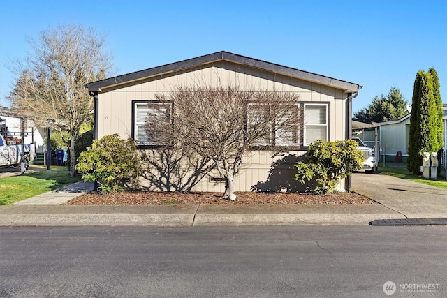 view of side of home featuring driveway