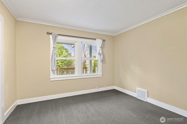 unfurnished room with visible vents, baseboards, ornamental molding, and dark carpet