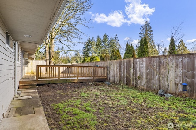 view of yard with a deck and a fenced backyard