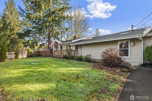 view of yard with a wooden deck and fence