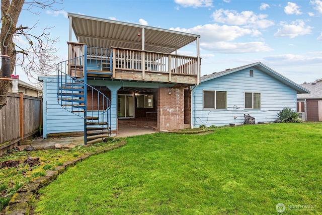 rear view of property with a lawn, a patio, stairway, fence, and a deck