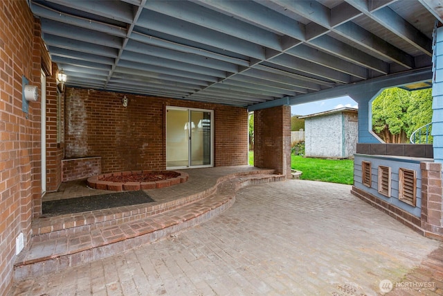 view of patio with a storage unit and an outbuilding