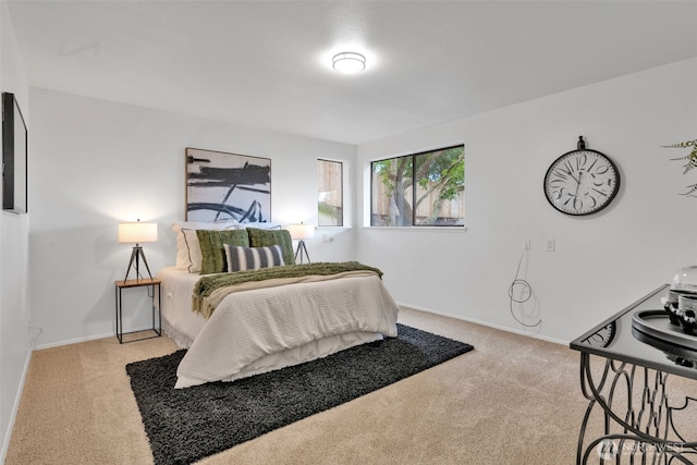 carpeted bedroom with baseboards