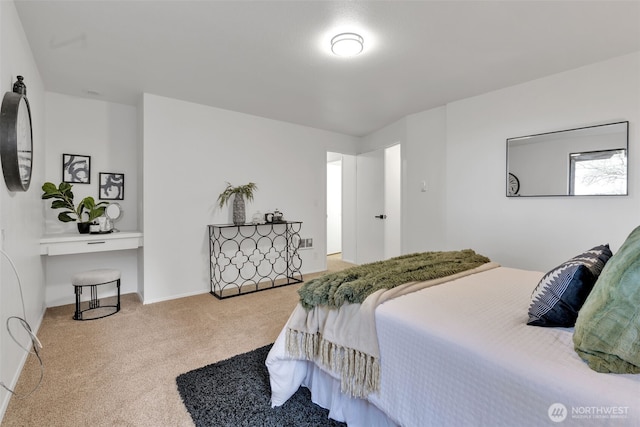 bedroom featuring carpet and baseboards